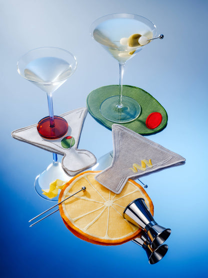 Set of cocktail glasses with garnishes on a blue background