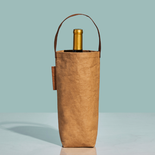 Brown wine bottle bag with a gold wine bottle on a light blue background