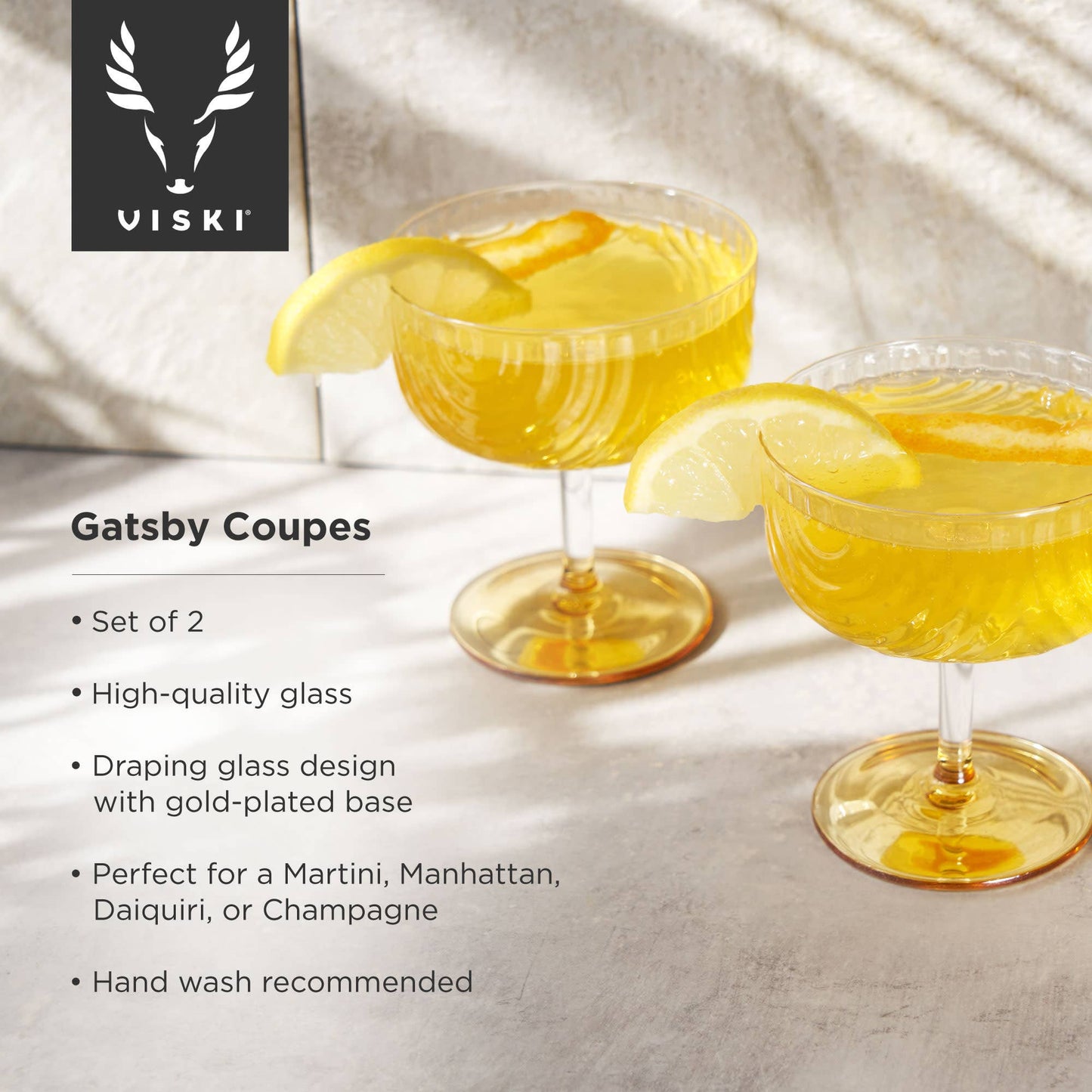 Two Gatsby Coupe glasses with lemon slices on a white background, featuring Viski branding.